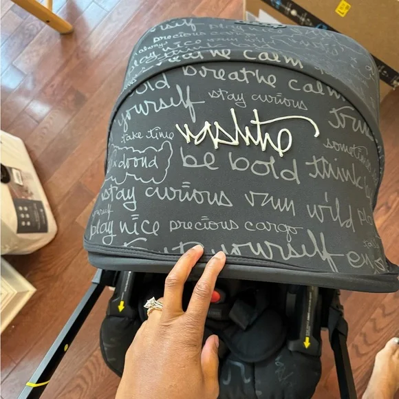 Doona Infant Car Seat & Stroller in Black with Yellow Accents - Picture 2 of 9